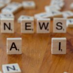 A journalist working with AI technology in a modern newsroom setting.