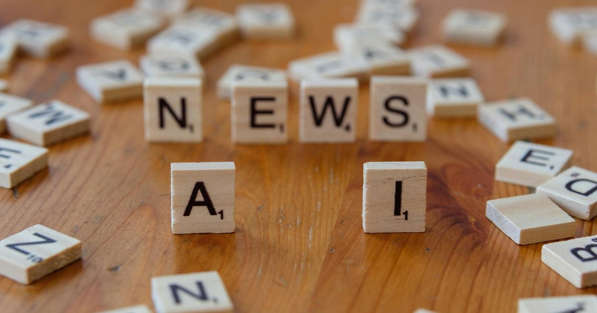 A journalist working with AI technology in a modern newsroom setting.