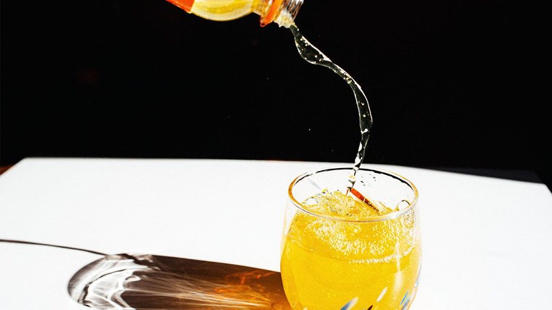 Orange liquid being poured into a glass