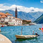A scenic view of Croatia's coastline with a car ready for travel.