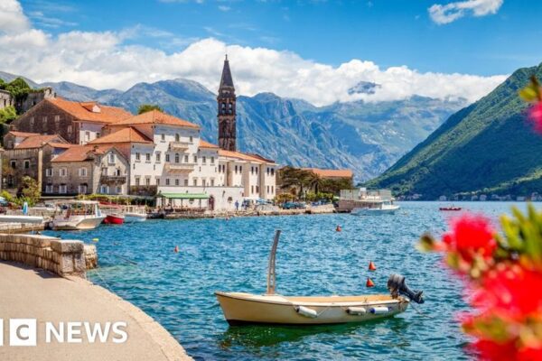 A scenic view of Croatia's coastline with a car ready for travel.
