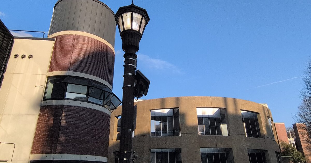 A cityscape depicting surveillance cameras as cities reconsider Flock technology.