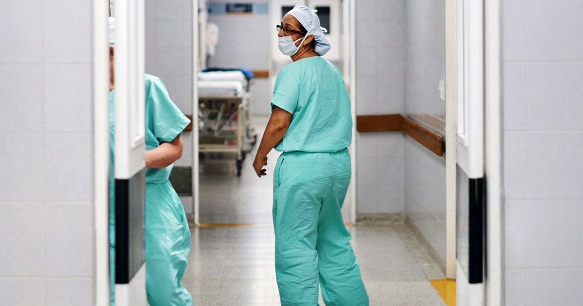 Healthcare workers in a hospital discussing HIV treatment advancements.