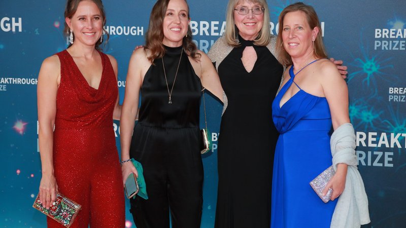 Esther, Janet, Susan, and Anne Wojcicki stand in formal dresses and pose.