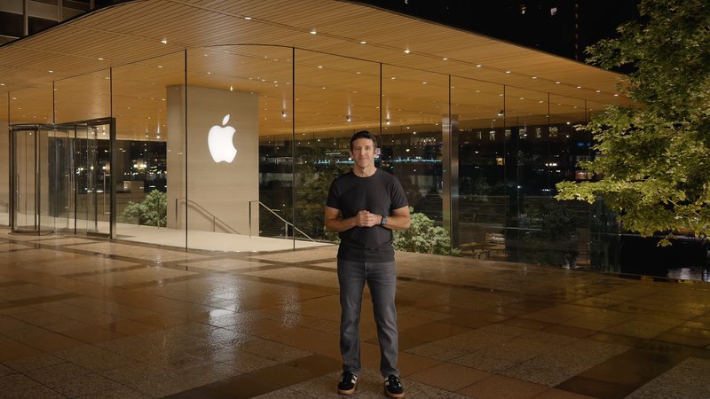John Ternus stands in front of an Apple Store