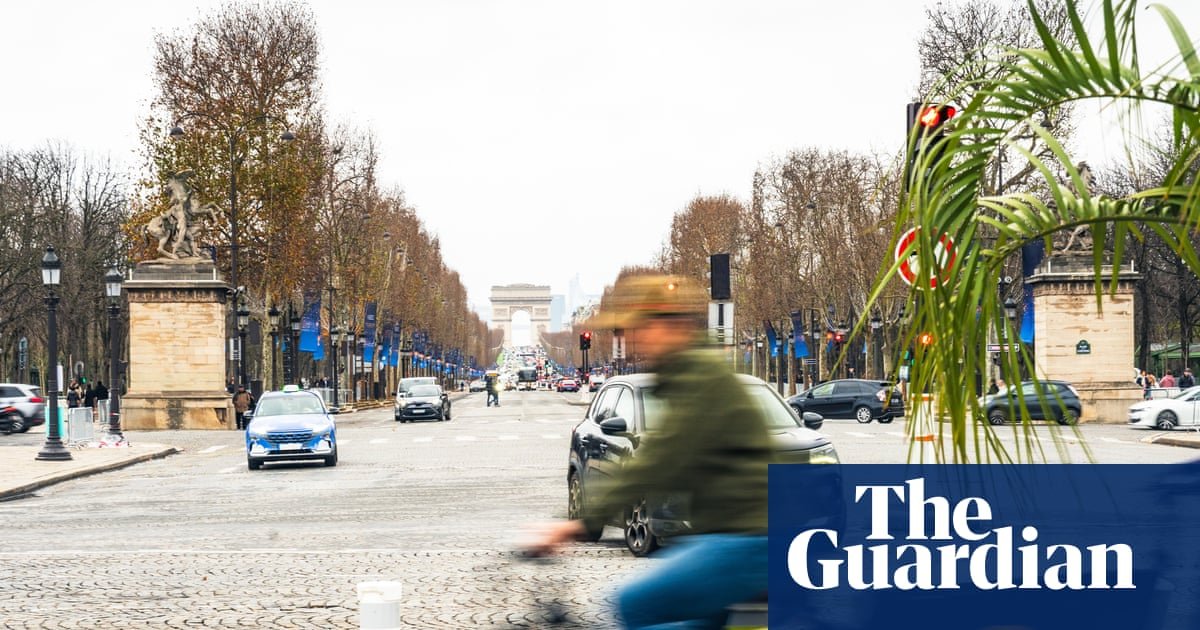 A cyclist navigating the new bike lanes in Paris, showcasing the city's transformation.