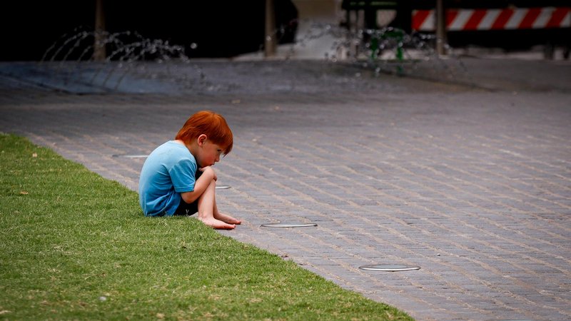 A child with red hair enjoying nature, symbolizing genetic diversity.