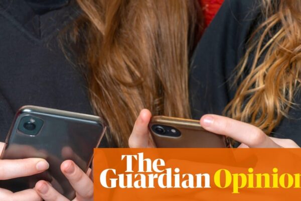 University students using smartphones in a classroom setting, highlighting digital distraction.