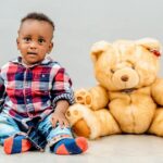 Teddy Afro performing live with vibrant Ethiopian cultural backdrop.