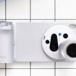 Close-up of a smartphone camera with a telephoto lens, showcasing photography capabilities.