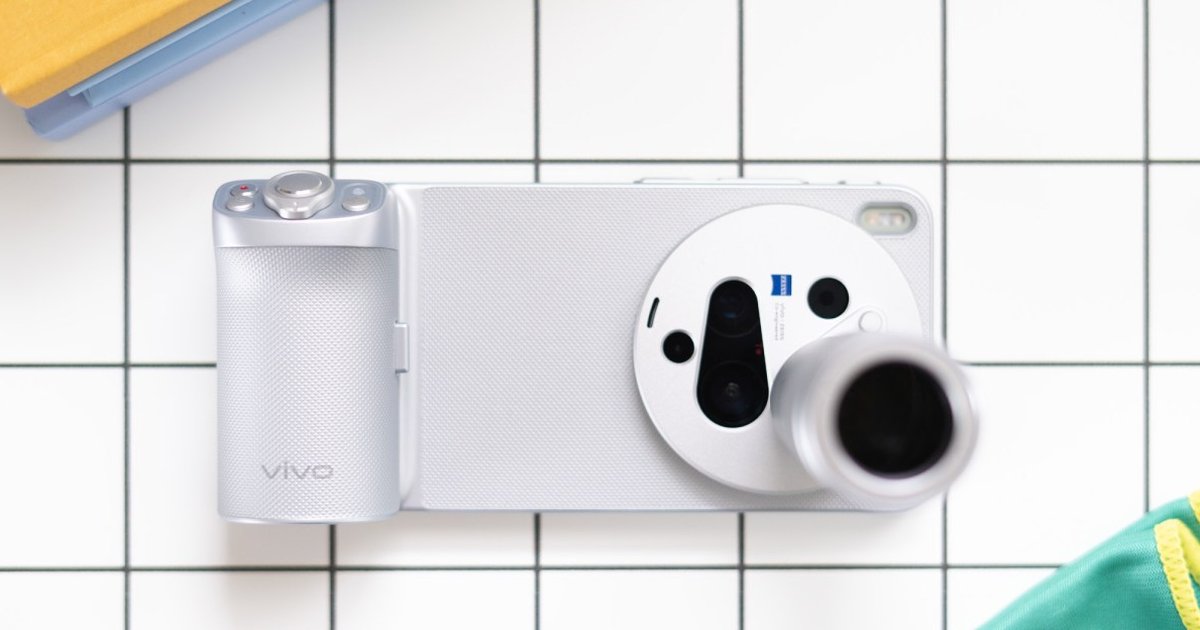 A close-up of a smartphone with a telephoto lens capturing a scenic view.